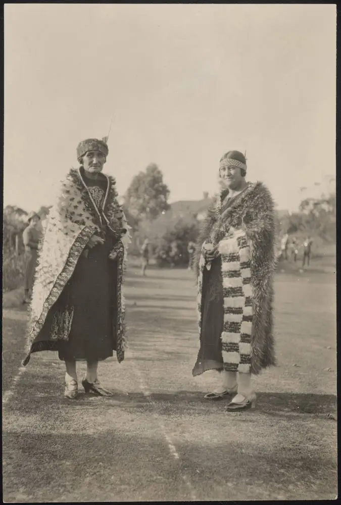 Two women wearing kahu huruhuru