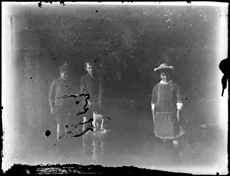 Donald?, Peter?, and Bo? Jenkins paddling with a pet dog