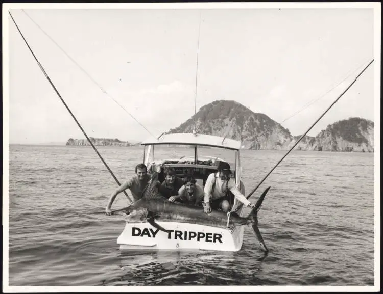 Anglers with a black marlin placed at the end of the boat 'Day Tripper'