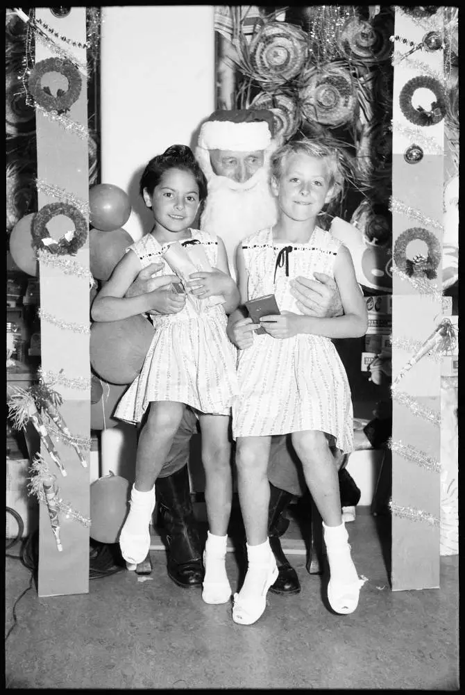 Children sitting on Santa's knee, 1959