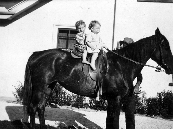 Graham Welch and Joan Wilton riding a horse : Photograph