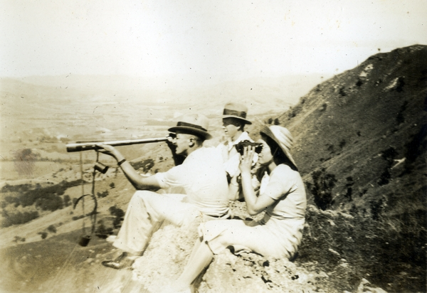 Two men and a woman on a hillside : Photograph