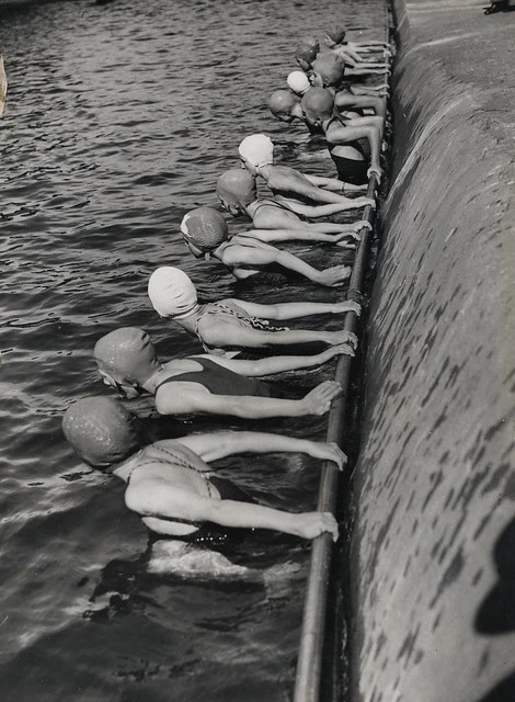 Swimmers during learn to swim week, at a suburban swimming pool, probably Wellington region, ca 1939