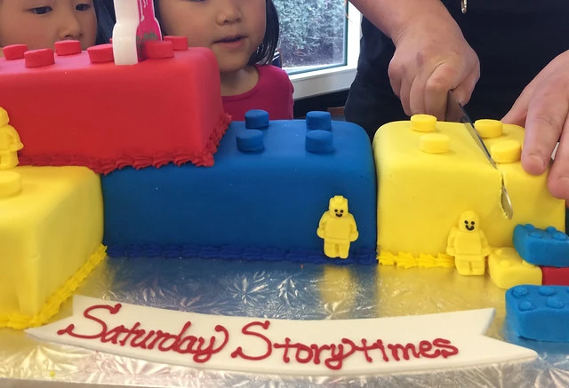 Cutting the Super Saturday Storytimes birthday cake