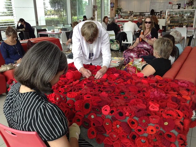 Sewing the poppies onto the blanket