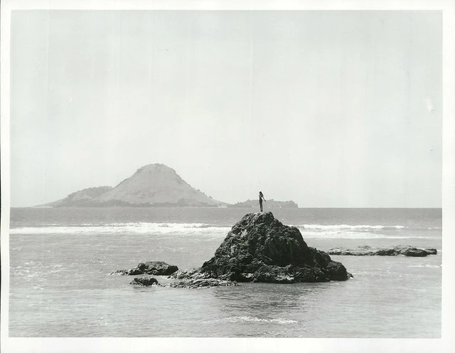 The statue of Wairaka at the entrance to the Whakatane River, Whale Island can be seen behind, Bay of Plenty