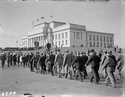 Anzac veterans marching towards the cenotaph in front of the Auckland War Memorial Museum.