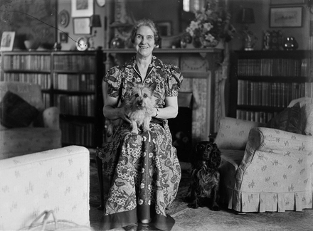 [Portrait of a woman with two dogs in a domestic setting]