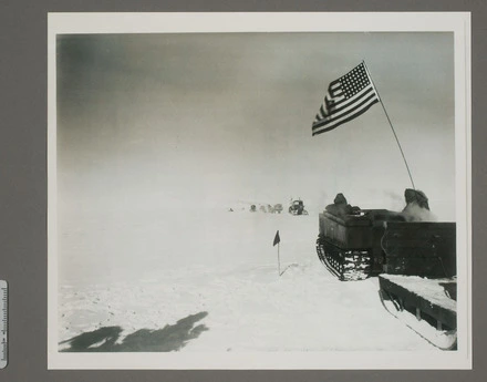 Dr V. Fuchs Trans-Antarctic Expedition approaching a greeting party including RADM G. Dufek and Sir Edmund Hillary and news correspondence 2 miles from the south pole station.