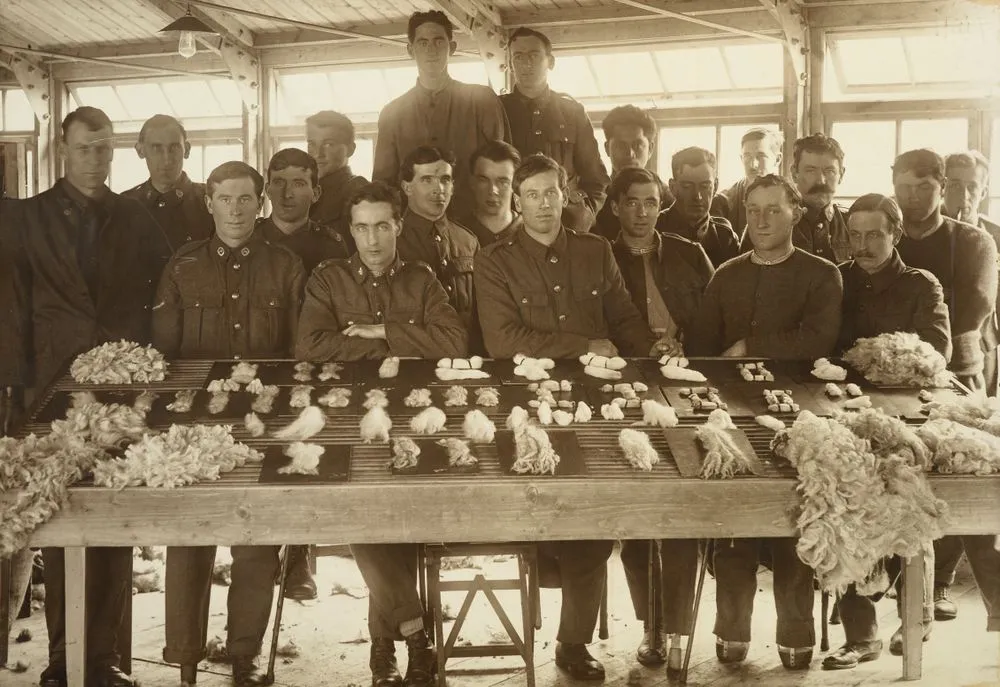 William Gemmell and nineteen unidentified WWI soldiers posed around a display of graded wool samples at Oatlands Park, Surrey, England