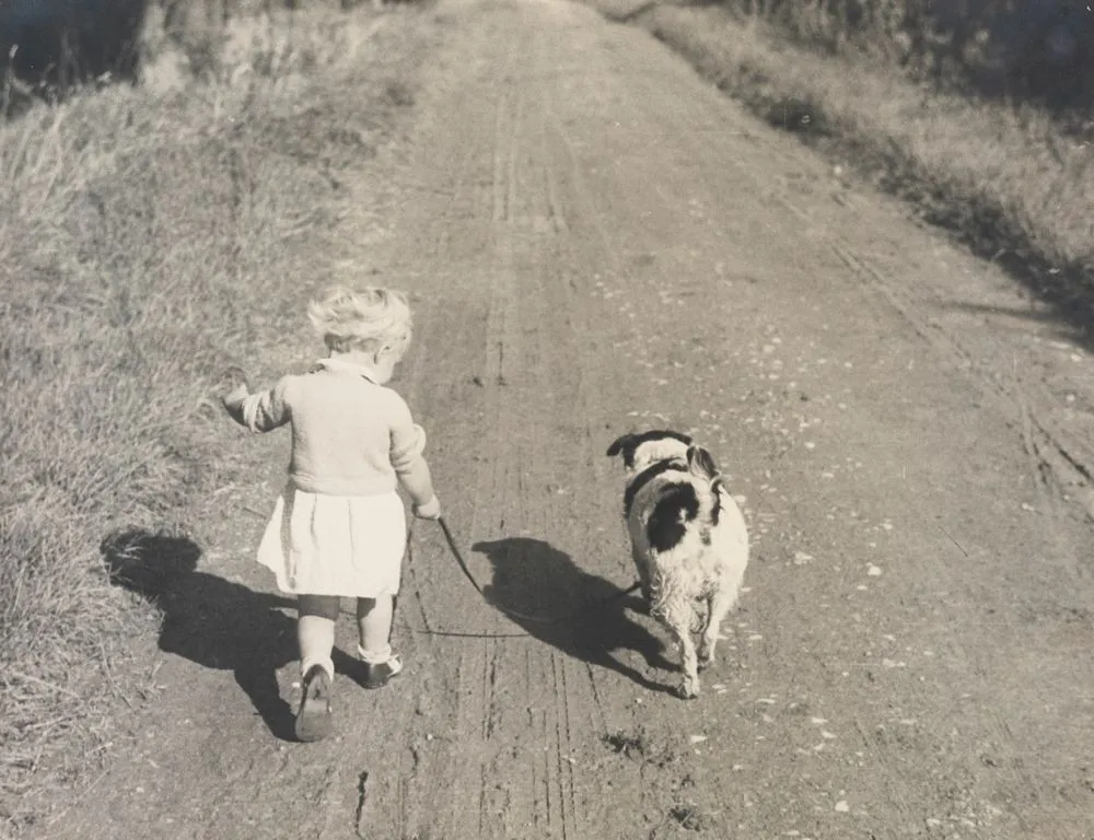 Joanna Johnson and dog on country road, England