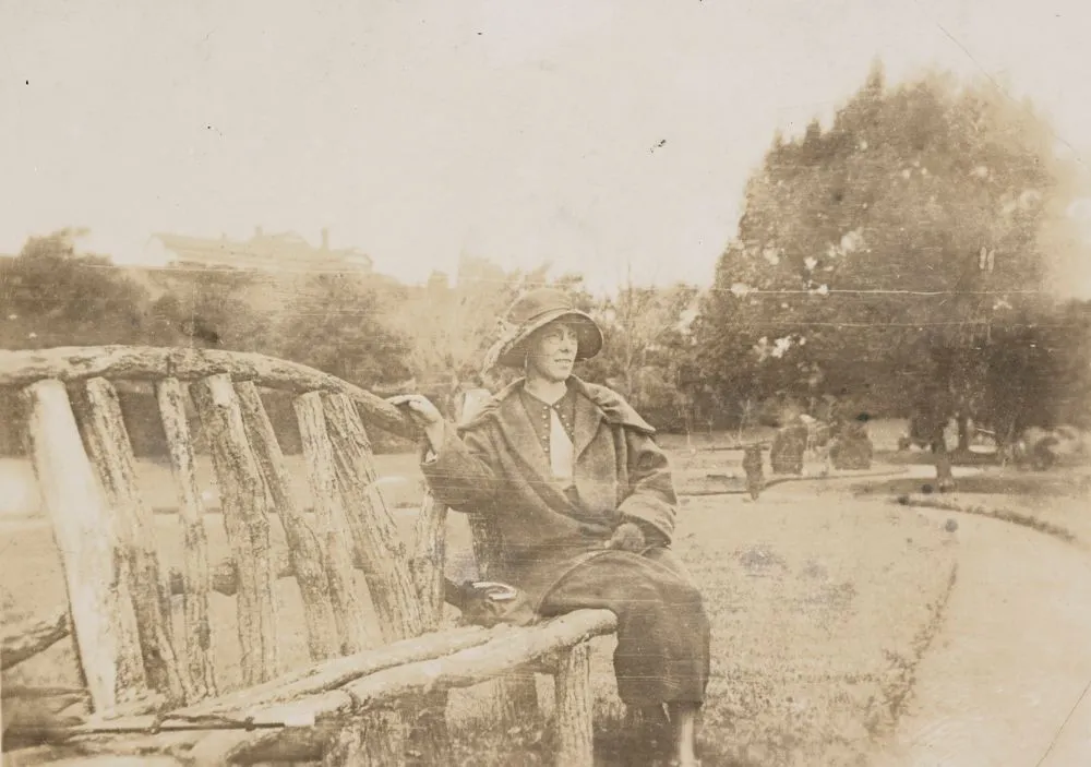 Woman on wooden park bench