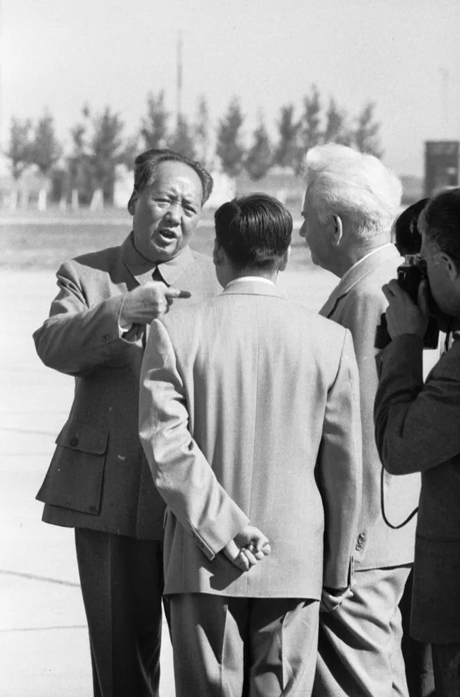 Chairman Mao Zedong talking to the leader of the East German delegation, Mr Hermann, at the airport, Beijing