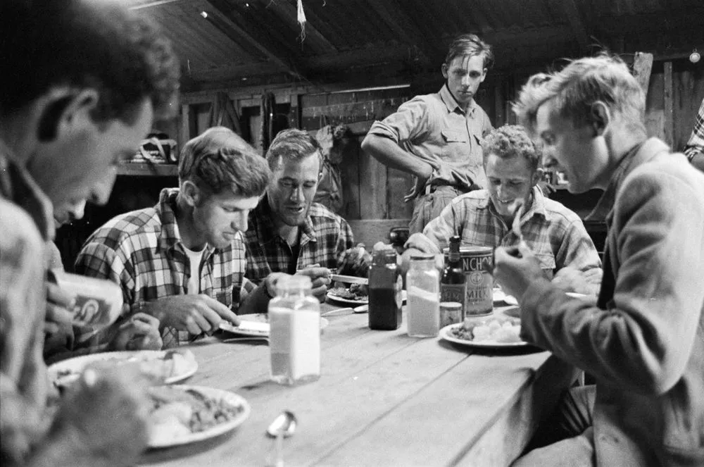 [Men dining in country hut]