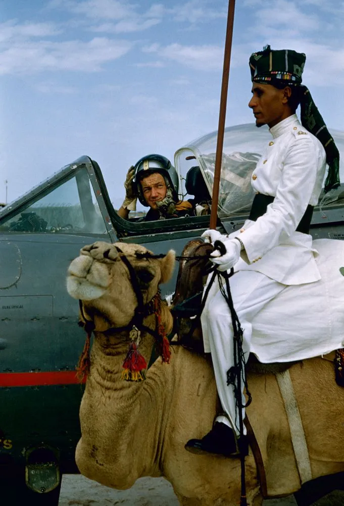 Camel rider of the Aden Protectorate Levies beside a jet plane on the RAF airfield, Aden, Yemen