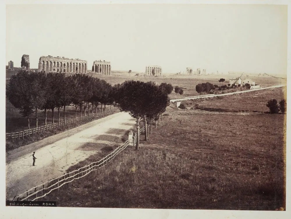 [country road with ruins in background]