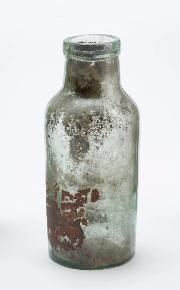 Bottle - Clear greenish glass with label