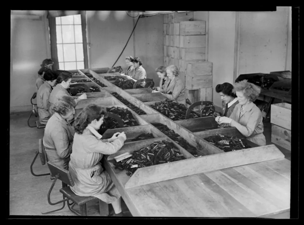 Women working metal punches - World War II production