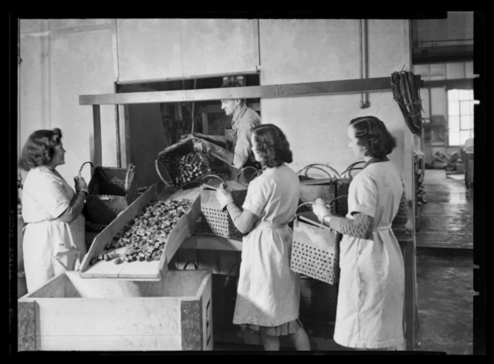 Women loading baskets with canteen corks - World War II production