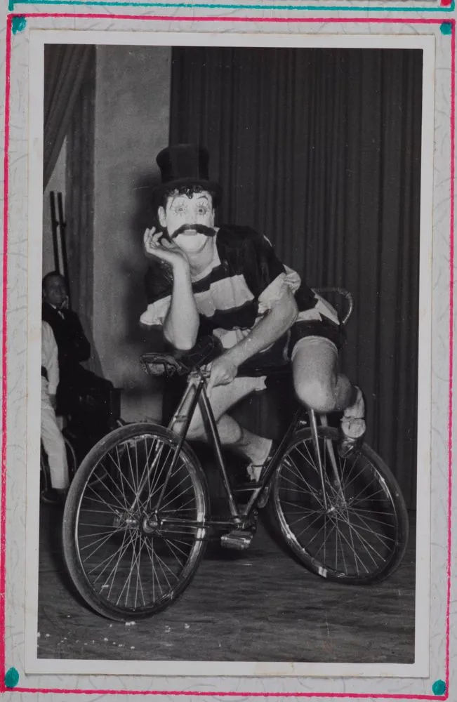 [clown riding bicycle]