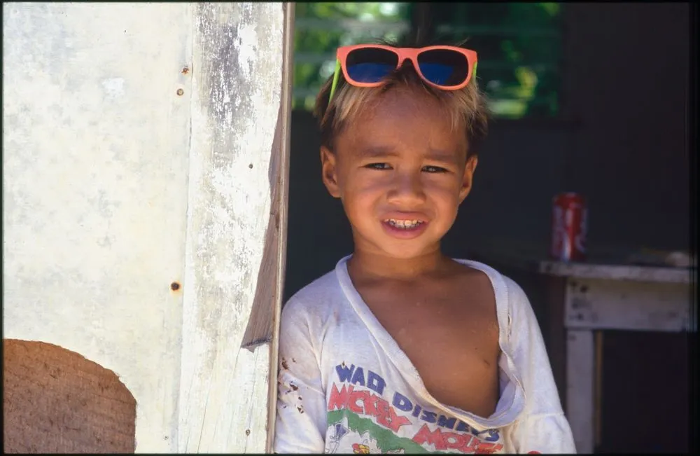 Child wearing pink framed sunglasses