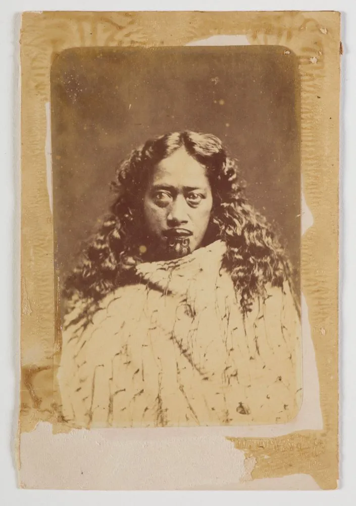 Maori woman with long hair, moko kauae, cloak.