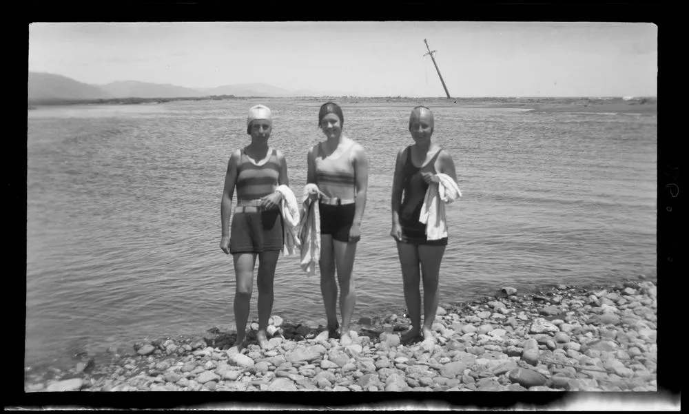 Three women at waters edge.