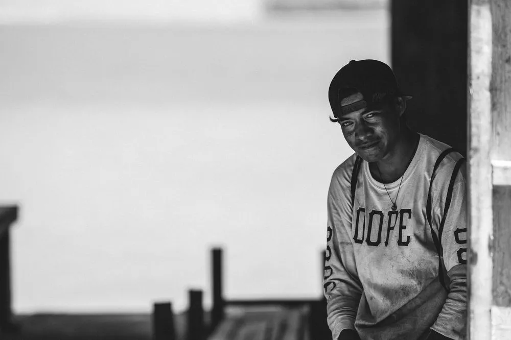 Black and white image of young man in 'Dope' shirt, Atafu, Tokelau