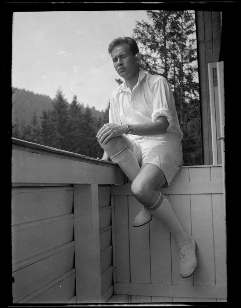 Man sitting on balcony of a house