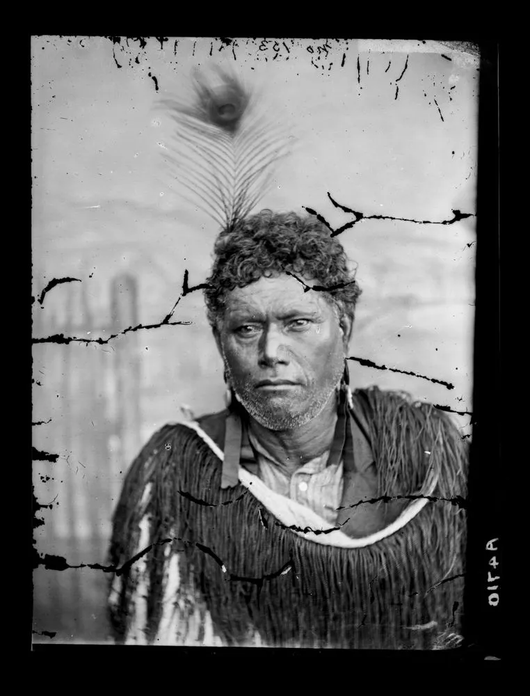 Maori man, moko, feather in hair, cloak