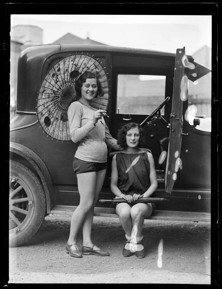 Two women beside car