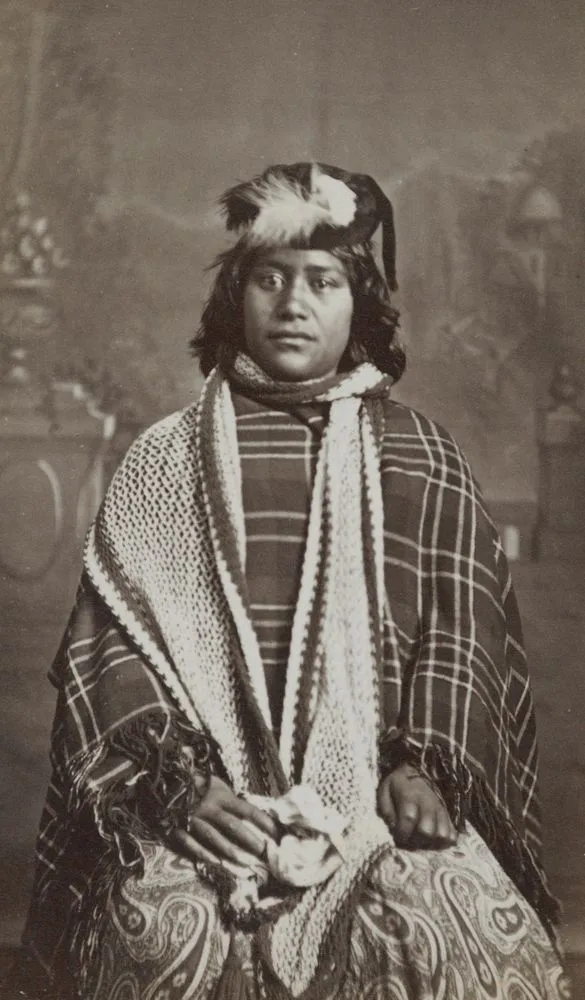 Maori woman wearing scarf and plaid blanket