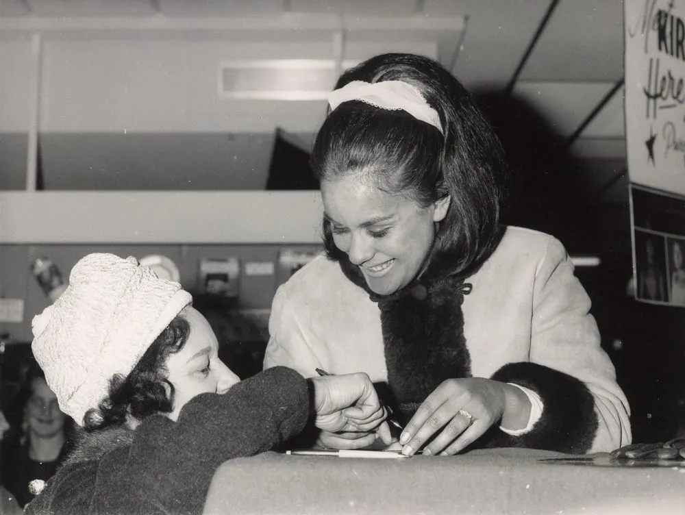 Kiri Te Kanawa signing an autograph