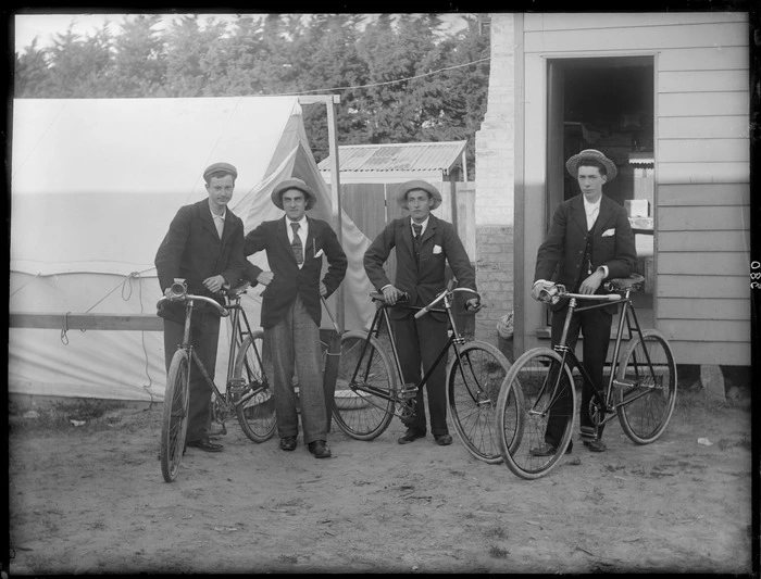 Four unidentified men wearing hats, with bicycles, probably Christchurch district