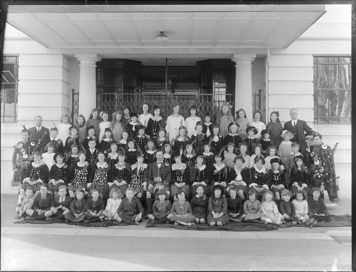 Group of unidentified children and adults, most in Scottish Highland costume outside the Caledonian Hall, Christchurch
