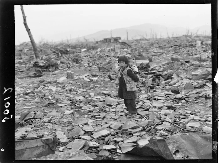 Hiroshima - Small child with baby on back searching for anything of usefulness