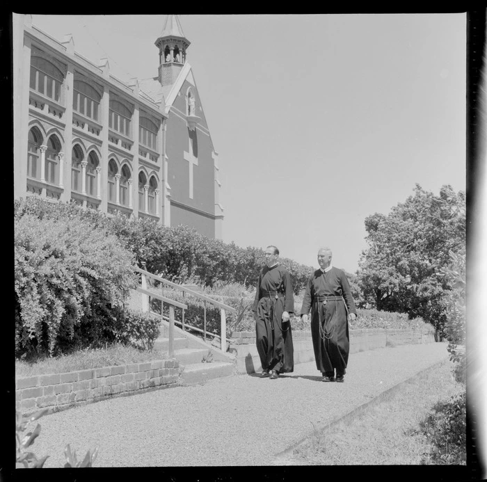 Two unidentified monks walking along a garden path at St Gerard's Monastery, Wellington