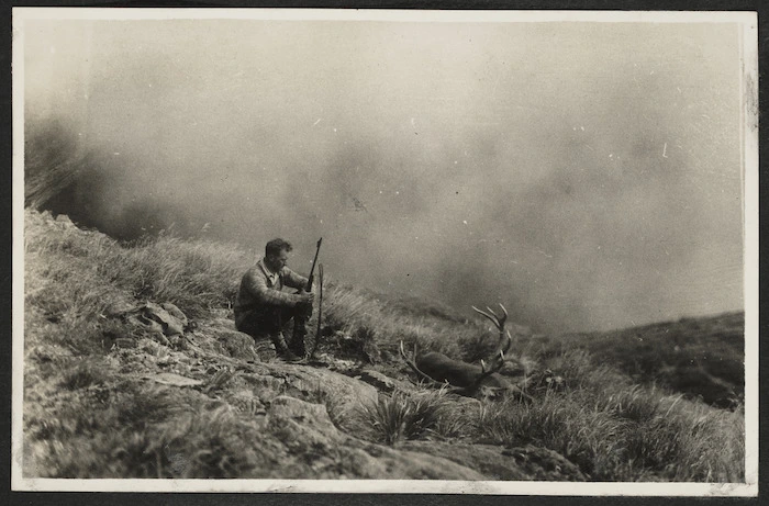 Arthur Gregg on hillside with gun and dead deer