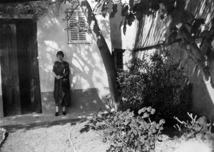 Katherine Mansfield standing in the garden at the Villa Isola Bella, Menton, France