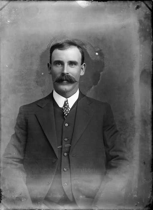 Portrait of unidentified man with round collar shirt, polka dot tie and handlebar moustache, probably Christchurch