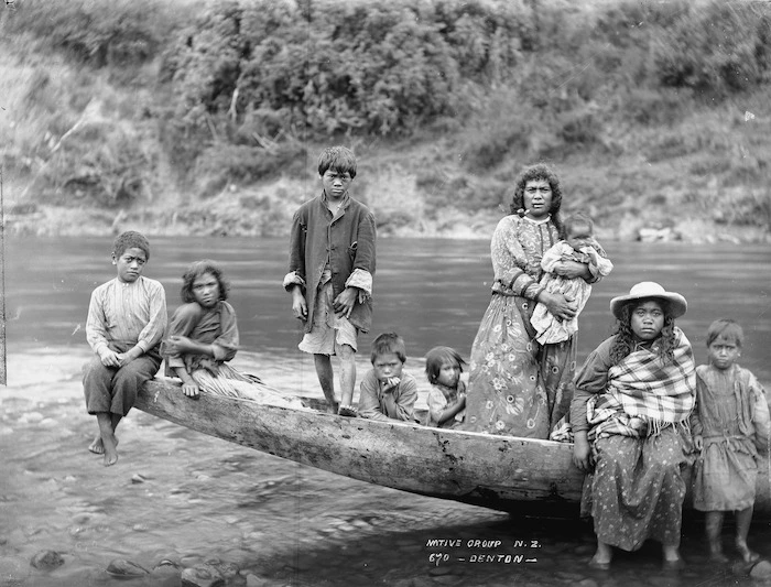Unidentified group sitting on the prow of a canoe