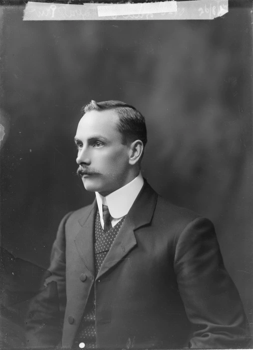 Studio portrait of a young man [Mr Royale?] with a moustache, wearing a suit, vest, collar and tie, Christchurch