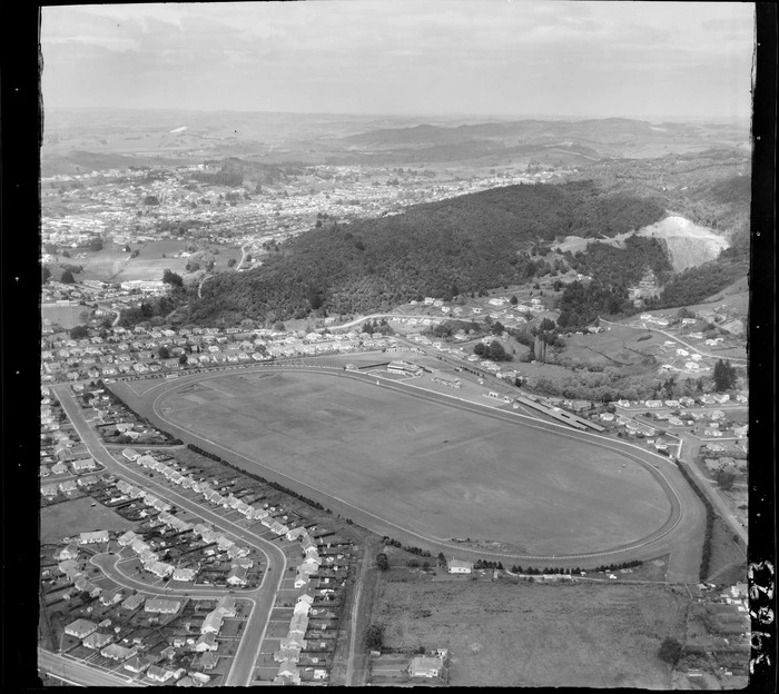 Whangarei, Northland, looking south over Kensington Racecourse (now Kensington Park) with Park Avenue road, with a quarry (now Quarry Gardens) surrounded in bush beyond