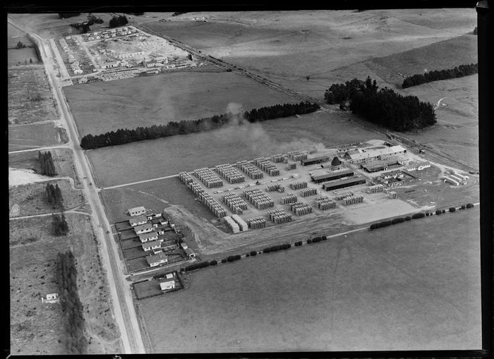 Egmont Box Company factory with saw mill and stacked lumber, with another lumber yard and workers housing beyond, Tokoroa, Waikato Region