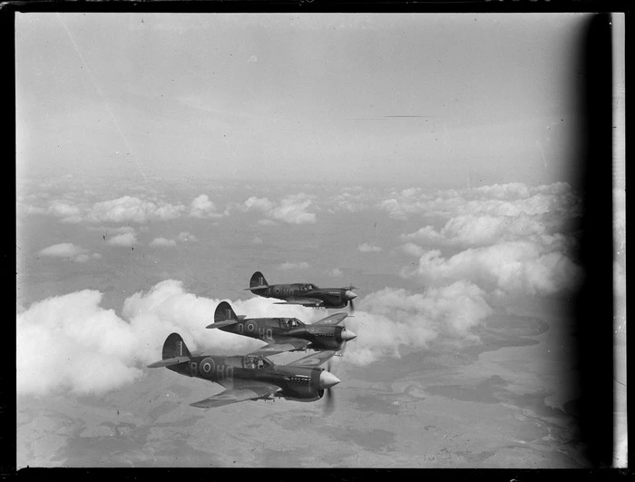 Three Curtiss P-40 Kittyhawk aircraft in flight