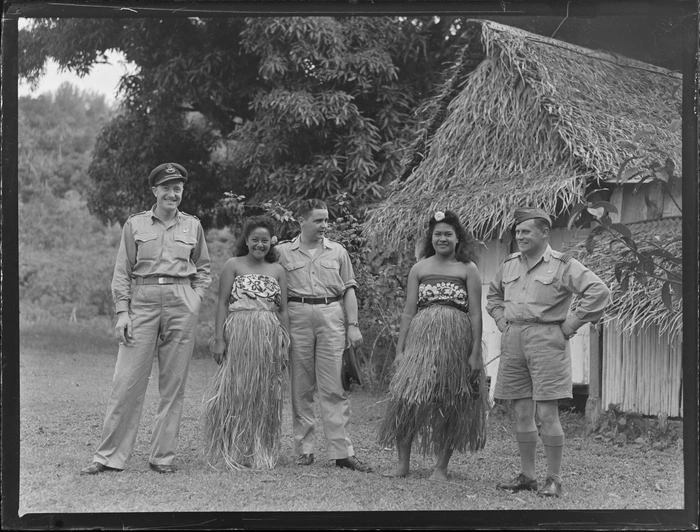 Unidentified RNZAF men with two unidentified local girls in island costume, Rarotonga, Cook Islands