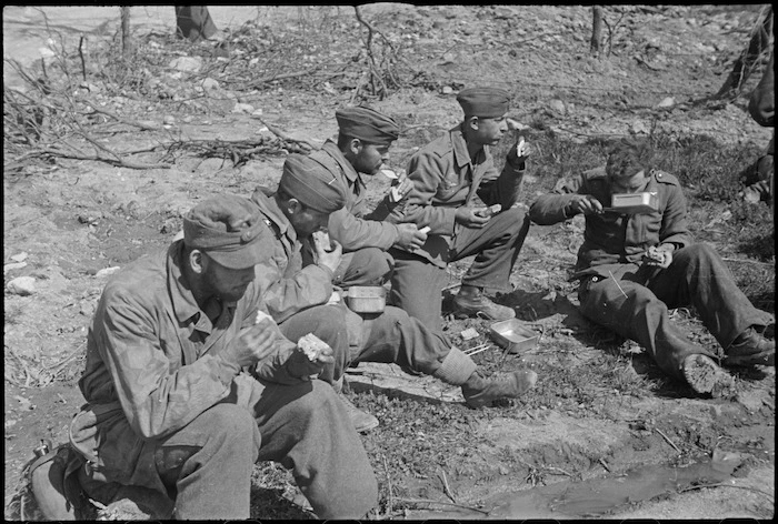 German soldiers eating Allied rations at a forward POW cage on the Cassino Front, Italy, World War II - Photograph taken by George Kaye