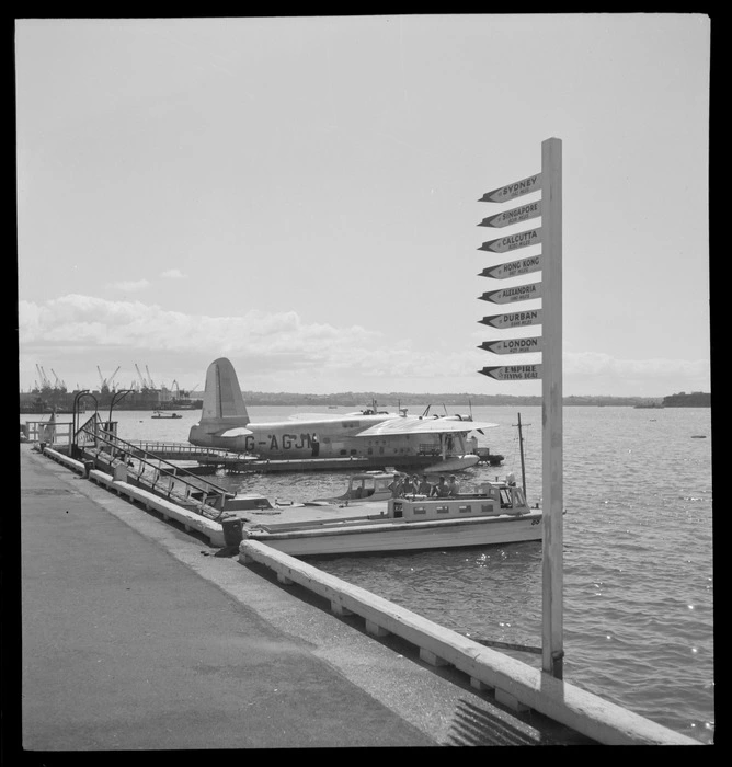 BOAC Hobart G-AGJM, a Short Hythe flying boat, Mechanics Bay, Auckland, includes a group of unidentified men in a charter boat