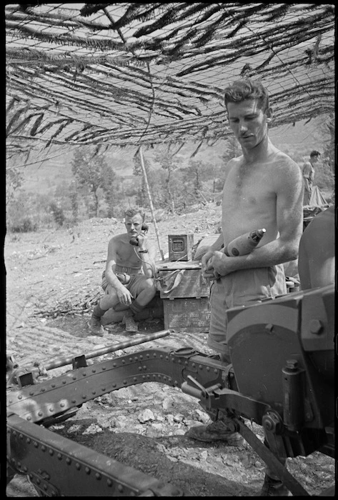 NZ Divisional Artillery gunner stands by as fire orders received in gun pit, Cassino Front, Italy, World War II - Photograph taken by George Kaye