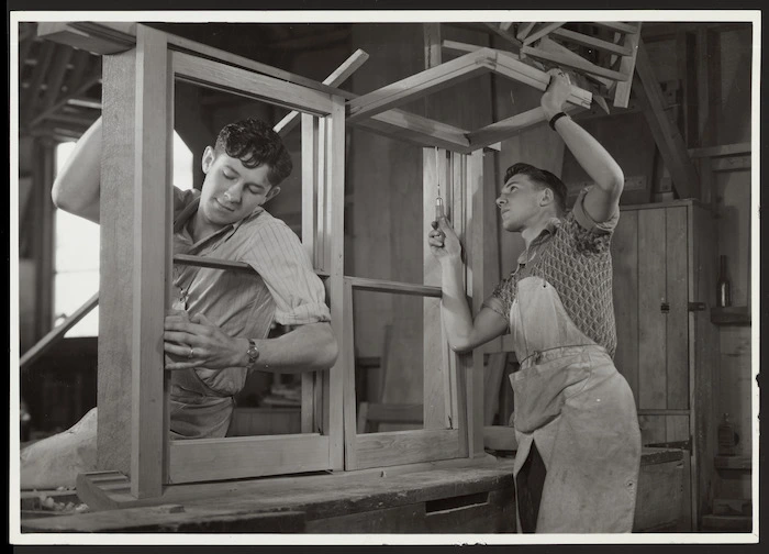 Carpenters working on window frames for state houses, New Zealand